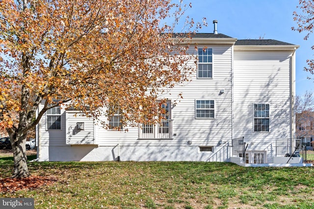 rear view of property with a yard