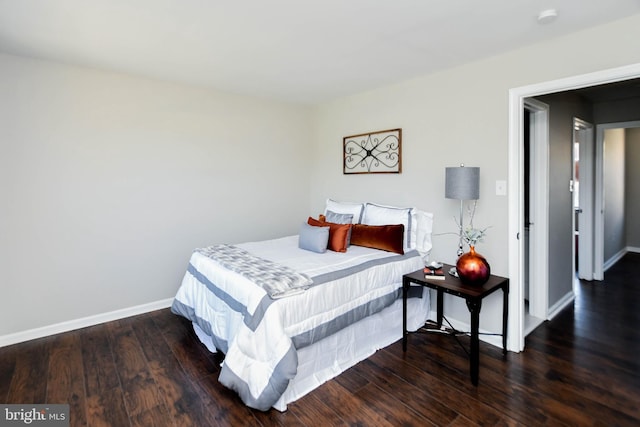 bedroom with dark wood-type flooring