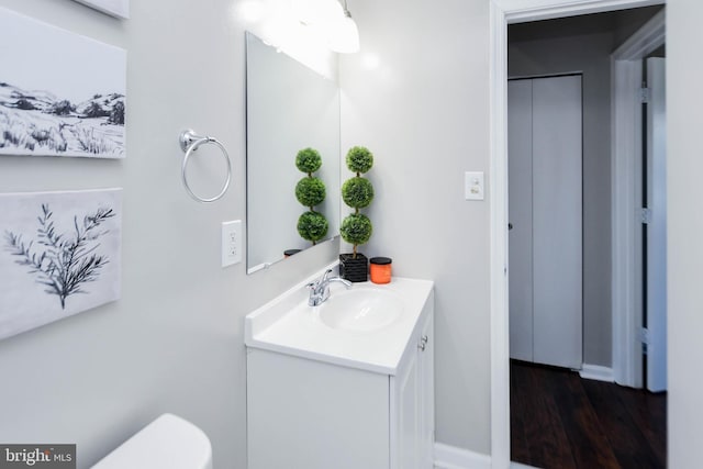 1140 1st St NW, Washington, DC 20001 - bathroom featuring toilet, baseboards, wood finished floors, and vanity