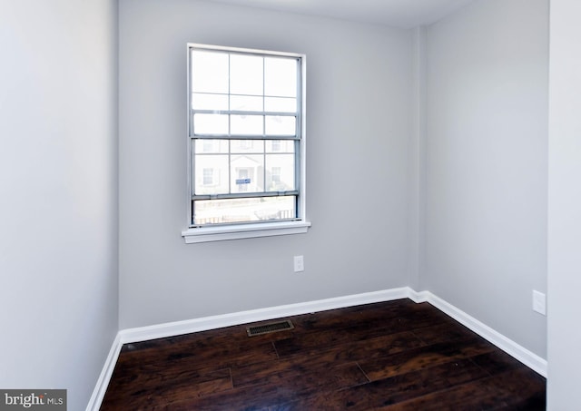 1140 1st St NW, Washington, DC 20001 - spare room featuring visible vents, dark wood-style flooring, and baseboards