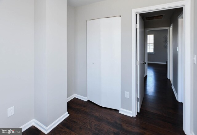 corridor featuring dark hardwood / wood-style flooring