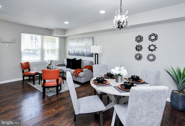 dining area featuring dark wood-type flooring and a notable chandelier