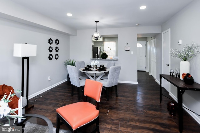 dining area featuring a chandelier and dark hardwood / wood-style flooring