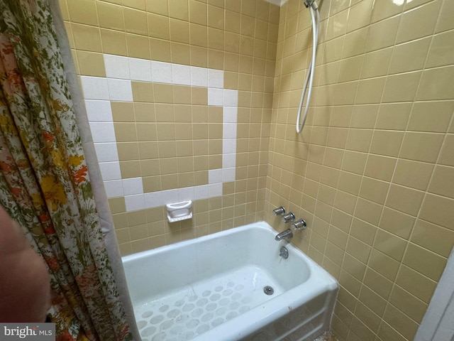 bathroom with shower / bath combo with shower curtain