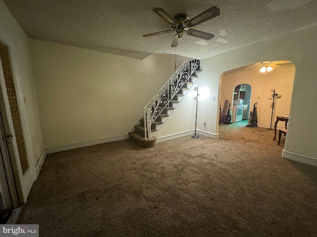 unfurnished living room with ceiling fan, a textured ceiling, and carpet flooring