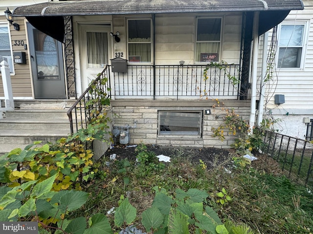 doorway to property featuring a porch