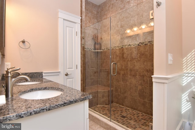 bathroom featuring vanity and a shower with shower door