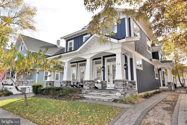 view of front of house with a porch and a front yard