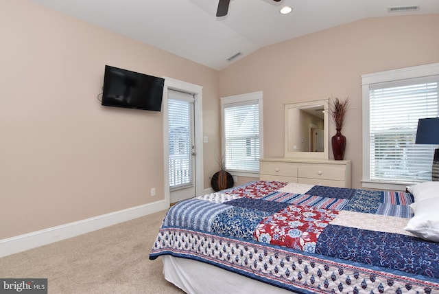 carpeted bedroom with multiple windows, lofted ceiling, and ceiling fan