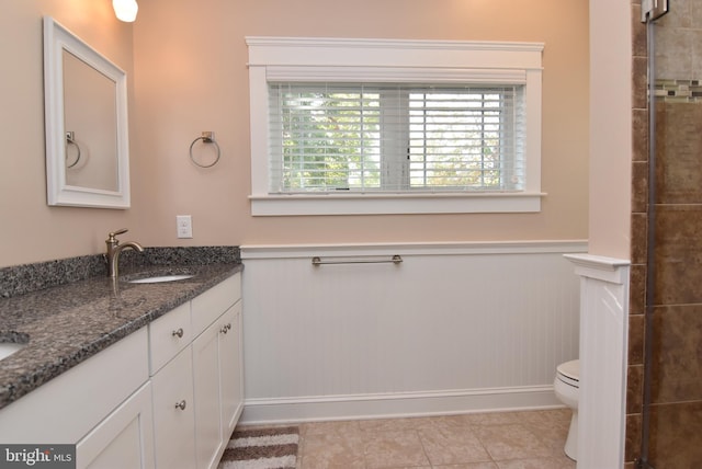 bathroom featuring toilet, vanity, and tile patterned floors