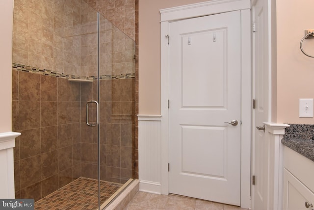 bathroom featuring an enclosed shower, vanity, and tile patterned floors