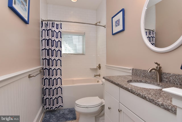 full bathroom featuring toilet, shower / tub combo, and vanity