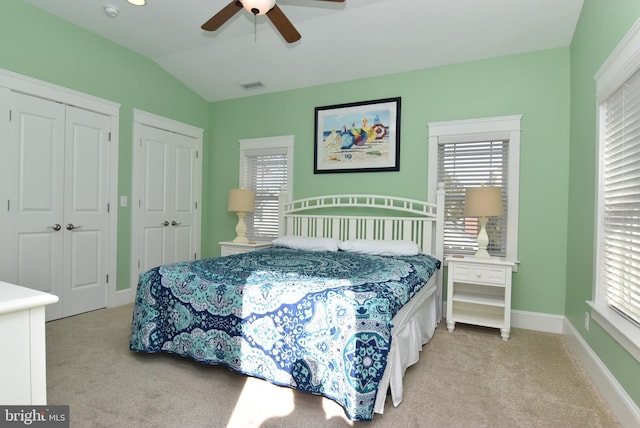 bedroom with light colored carpet, ceiling fan, and vaulted ceiling