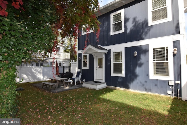 back of house featuring a patio area and a yard