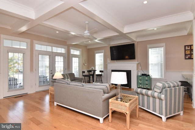 living room with ceiling fan, beamed ceiling, light wood-type flooring, and coffered ceiling