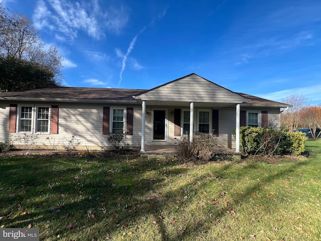 single story home with covered porch and a front yard