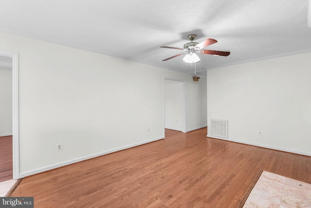 unfurnished room with ceiling fan, light wood-type flooring, and a textured ceiling