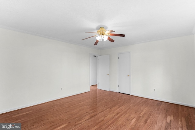 unfurnished room featuring hardwood / wood-style flooring, ceiling fan, and ornamental molding