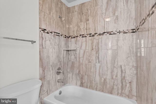 bathroom featuring tiled shower / bath combo, toilet, and ornamental molding