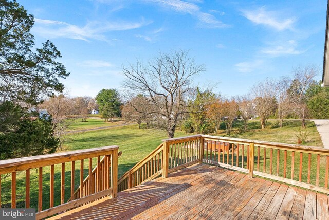 wooden terrace featuring a yard