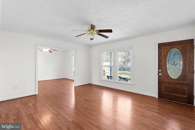 entryway featuring hardwood / wood-style floors and a textured ceiling