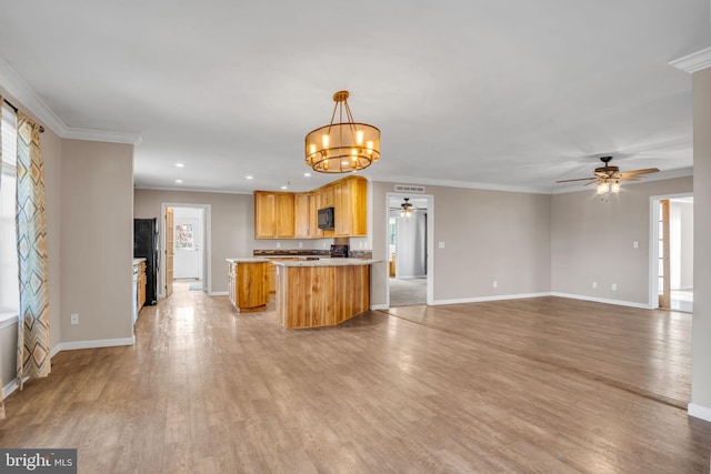 kitchen featuring light hardwood / wood-style flooring, crown molding, a center island, decorative light fixtures, and ceiling fan with notable chandelier