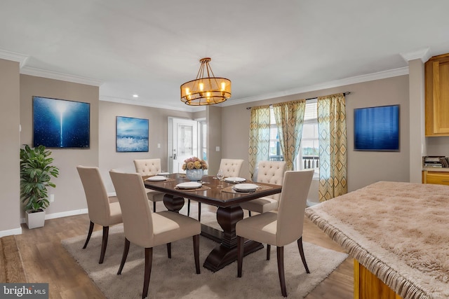 dining space featuring crown molding, an inviting chandelier, and dark hardwood / wood-style floors