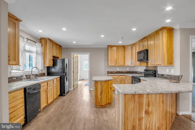 kitchen with kitchen peninsula, ornamental molding, black appliances, light hardwood / wood-style floors, and sink