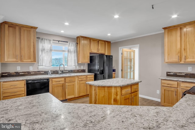 kitchen featuring light hardwood / wood-style floors, black appliances, and light stone counters