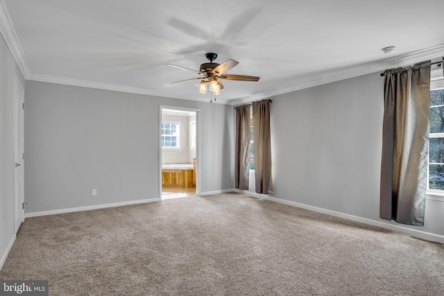 spare room with crown molding, a ceiling fan, baseboards, and carpet floors