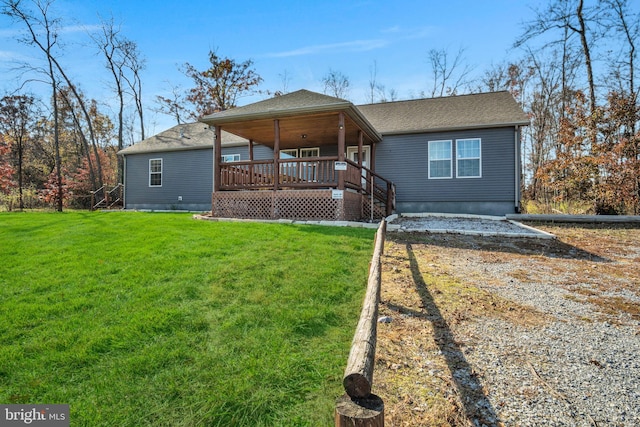 view of front of property with dirt driveway, a front lawn, and roof with shingles