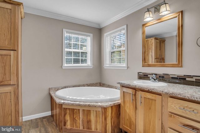 bathroom featuring ornamental molding, decorative backsplash, wood finished floors, a bath, and vanity