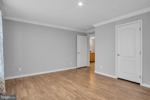 unfurnished bedroom featuring crown molding and light hardwood / wood-style floors