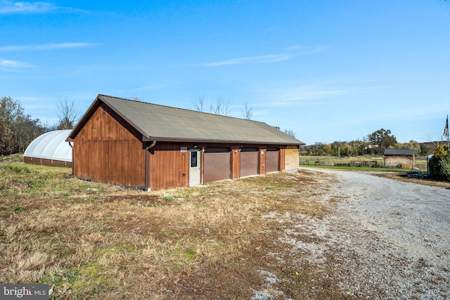 view of outbuilding featuring a garage and an outdoor structure