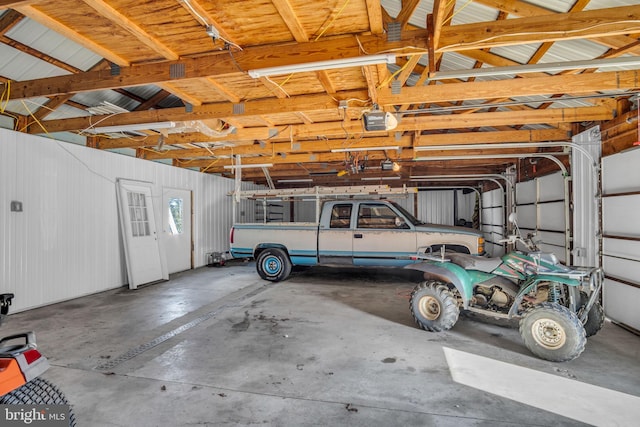 garage featuring a garage door opener and metal wall