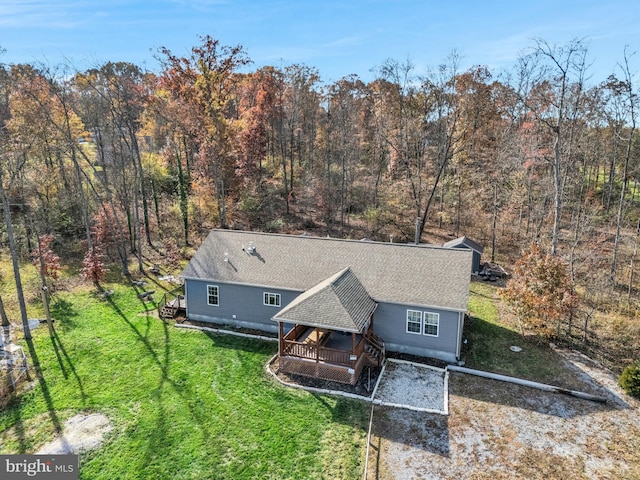 birds eye view of property with a view of trees