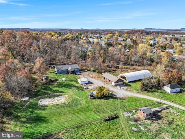 drone / aerial view featuring a forest view