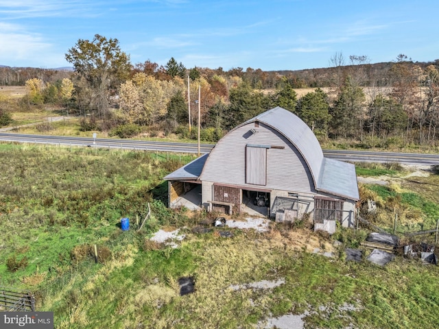 view of barn featuring a view of trees