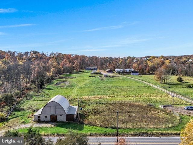 birds eye view of property with a rural view and a view of trees