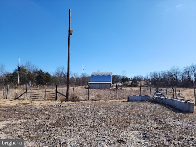 view of yard with a rural view and fence