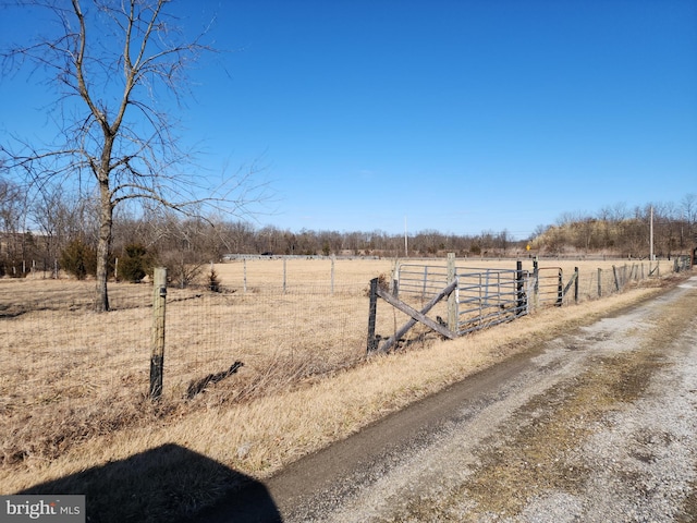 view of yard featuring a rural view and fence