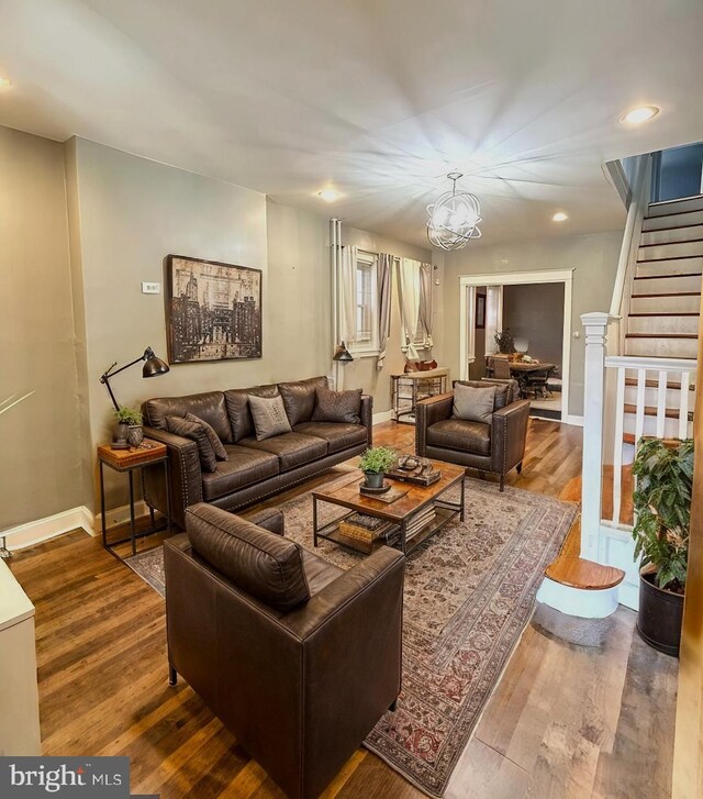 living room featuring hardwood / wood-style flooring and a chandelier