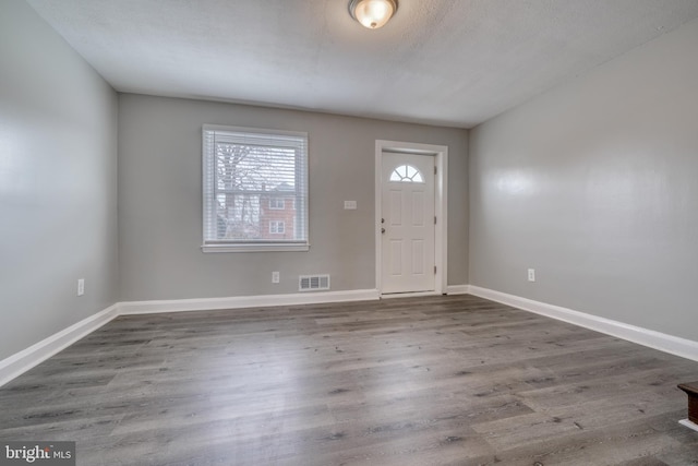 entryway featuring hardwood / wood-style floors and a textured ceiling