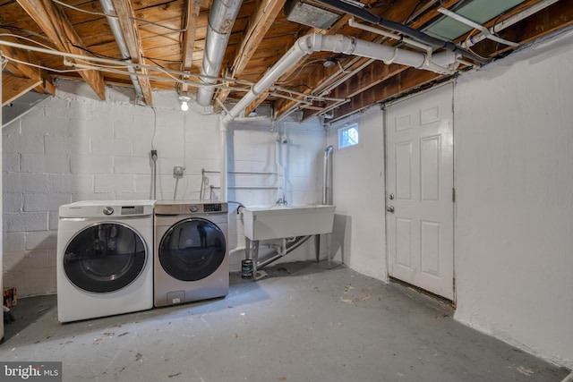 basement featuring sink and washer and dryer