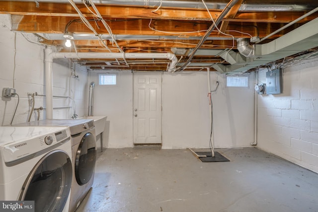 basement featuring electric panel and separate washer and dryer