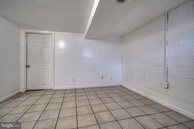 basement with light tile patterned flooring