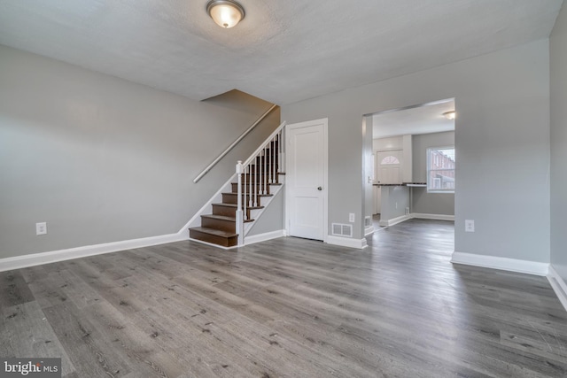 interior space featuring wood-type flooring and a textured ceiling