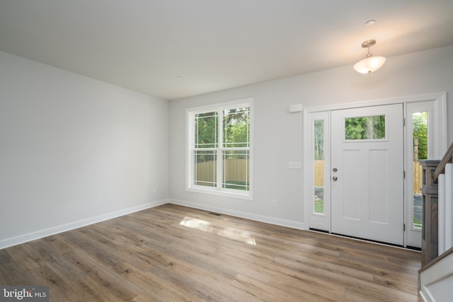 entryway with light hardwood / wood-style floors