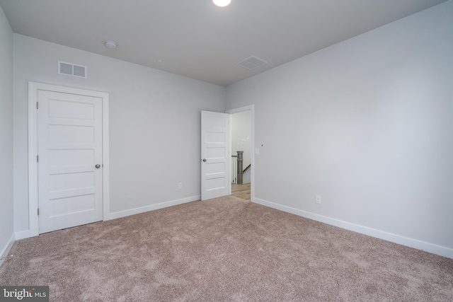 unfurnished bedroom featuring light colored carpet