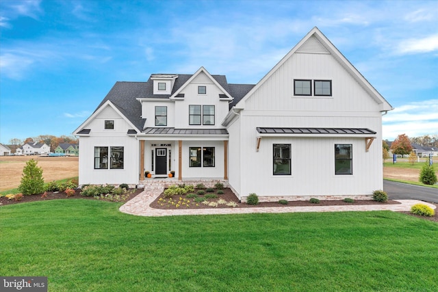 modern inspired farmhouse with a front lawn